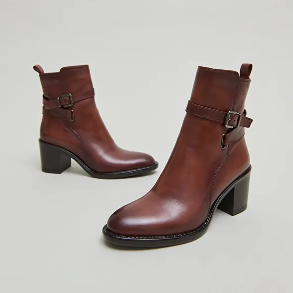 Heeled ankle boots and buckles in cognac leather